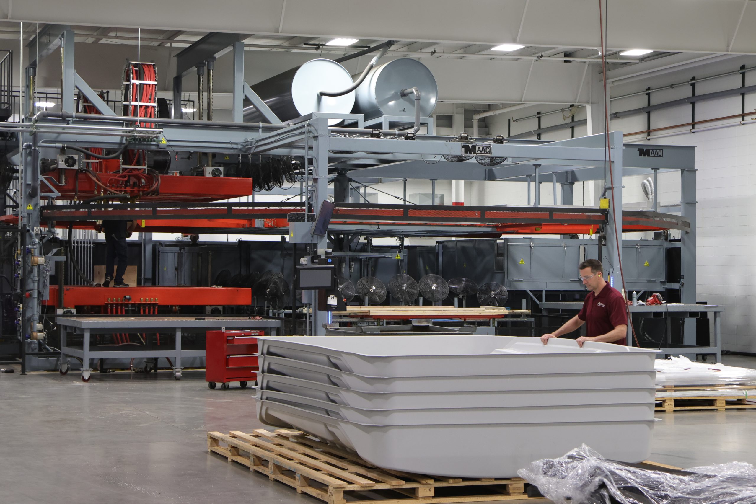 A worker at Allied Plastics works with thermoforming equipment as part of his role in manufacturing plastic